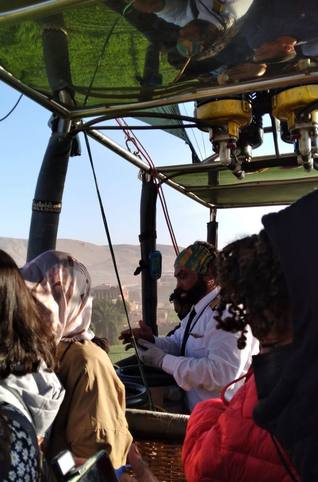 A group of people are sitting in a hot air balloon
