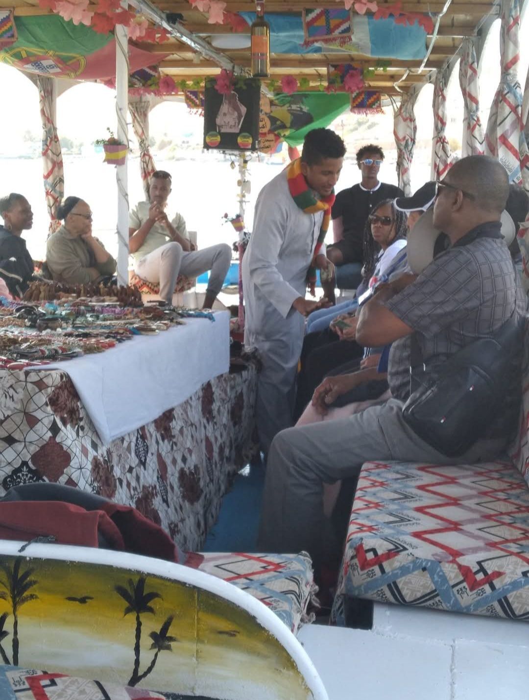A group of people are sitting on a boat talking to each other