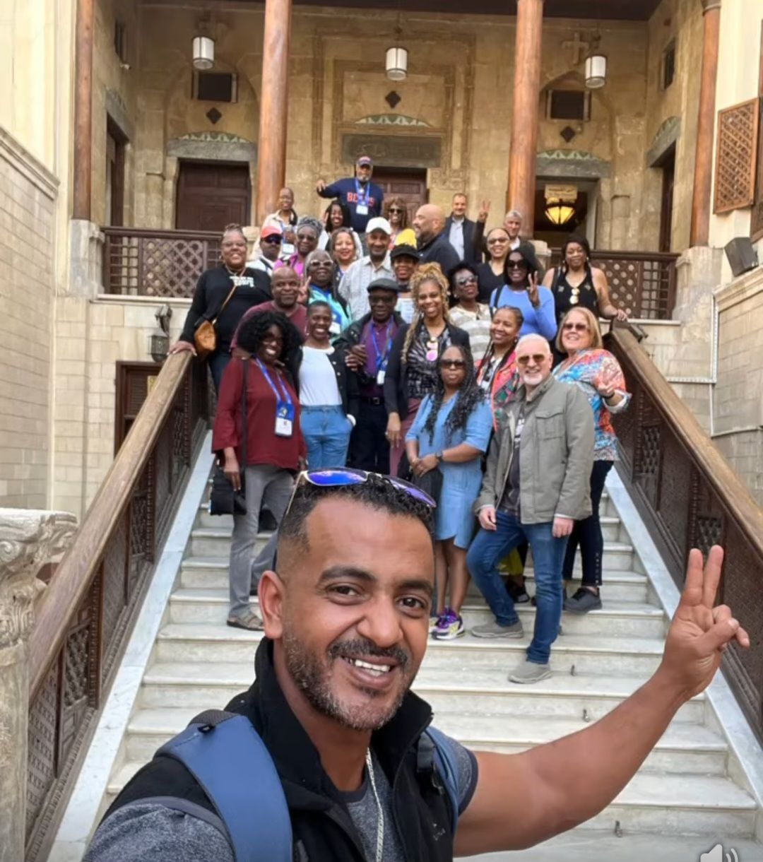 A group of people are posing for a picture on a set of stairs