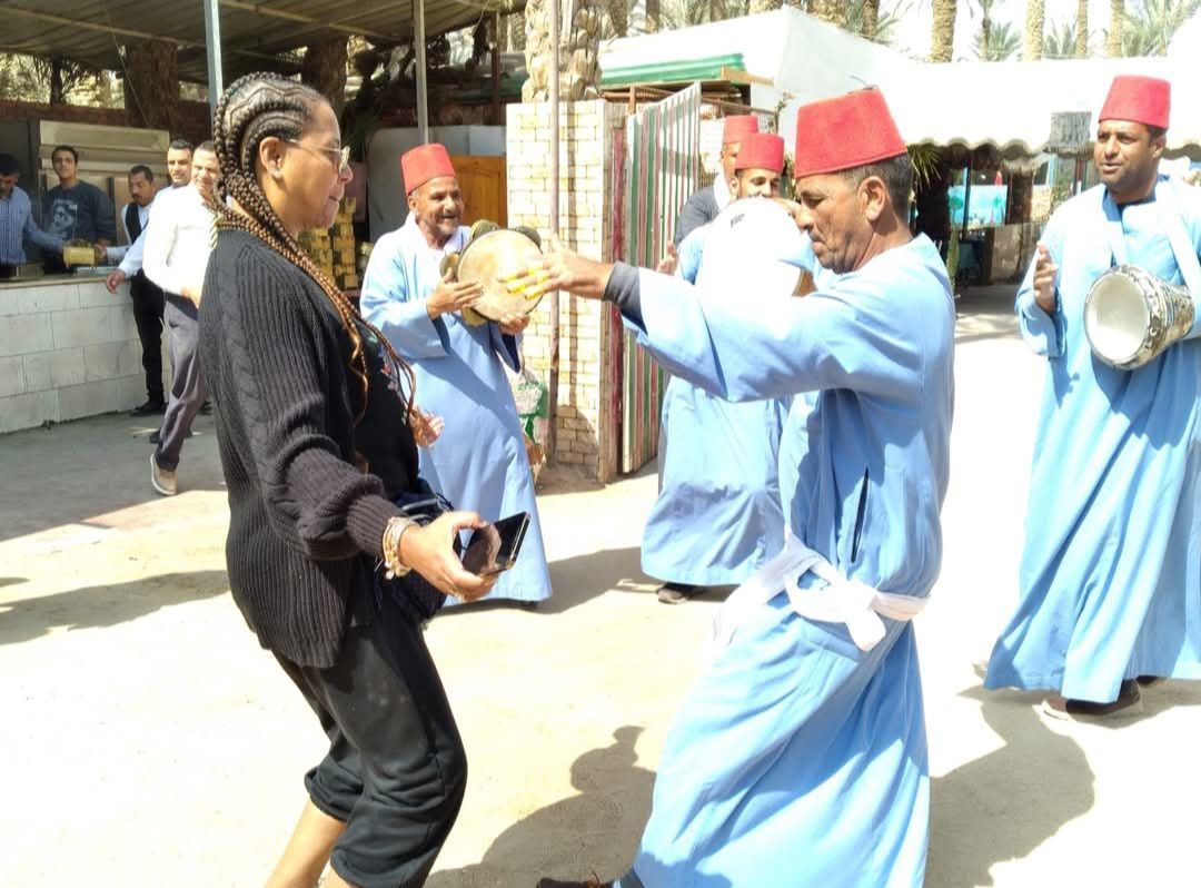 A group of men in blue robes are playing drums