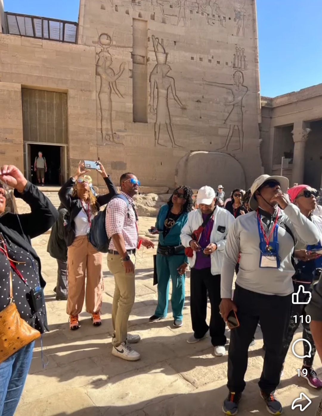 A group of people are standing in front of a building.