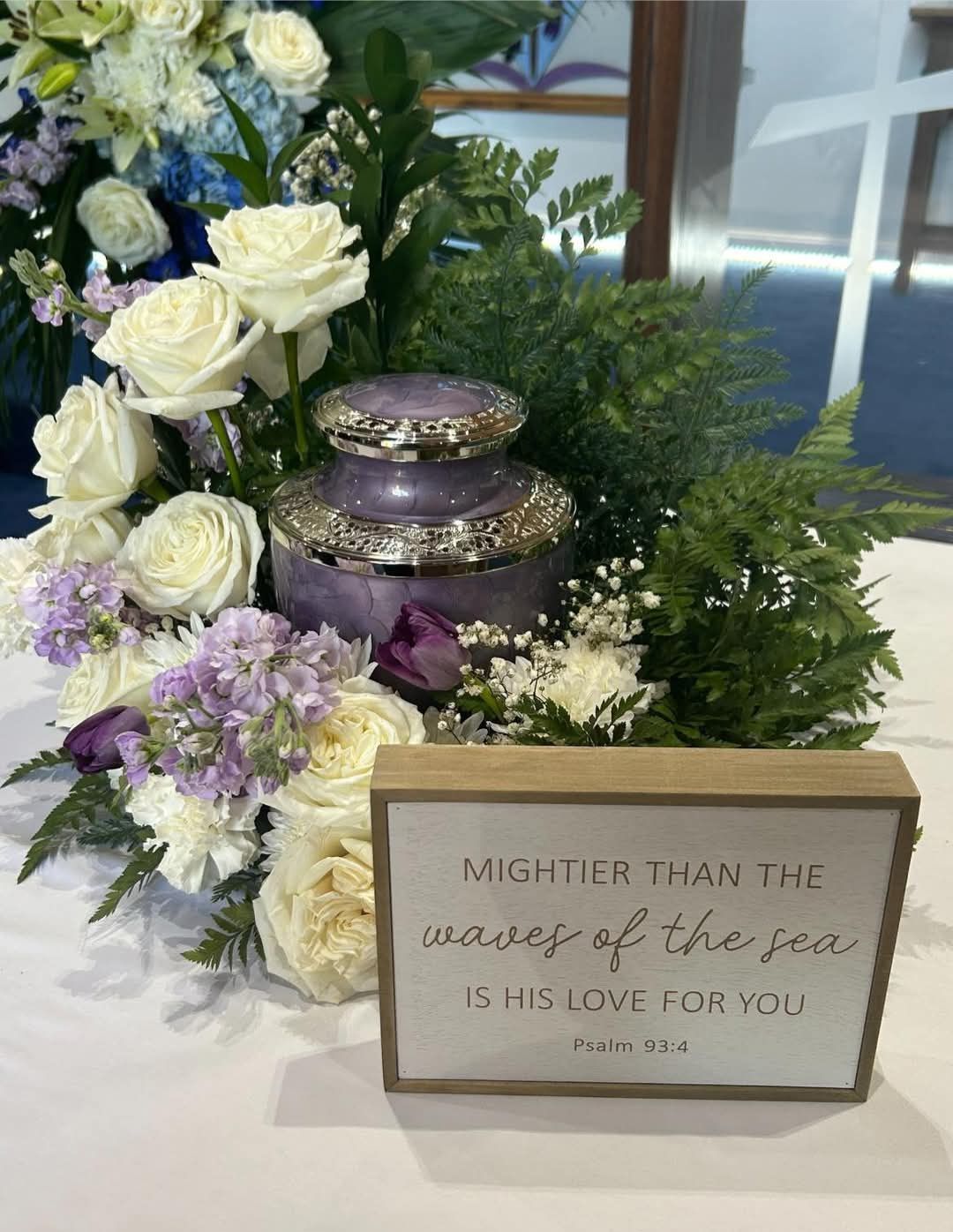 There is a sign that says `` mightier than the waves of the sea is his love for you ''.