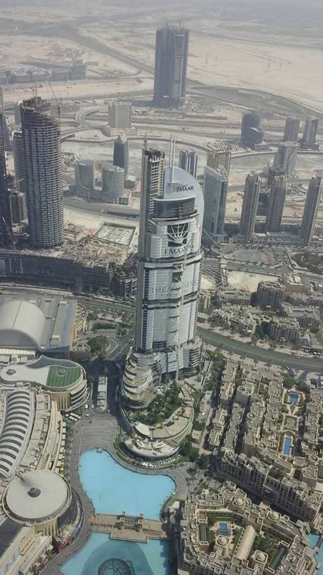 An aerial view of a city with a large building in the middle
