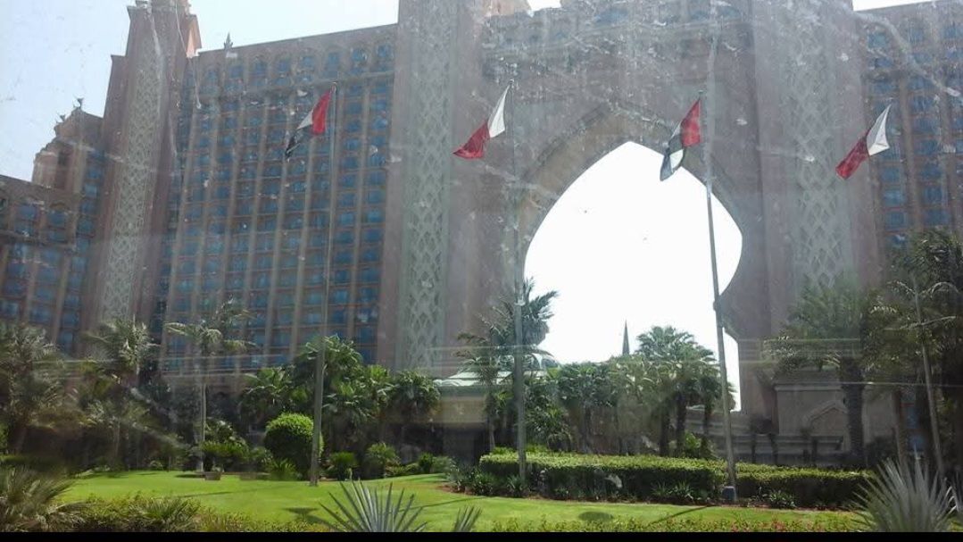 A large building with flags flying in front of it