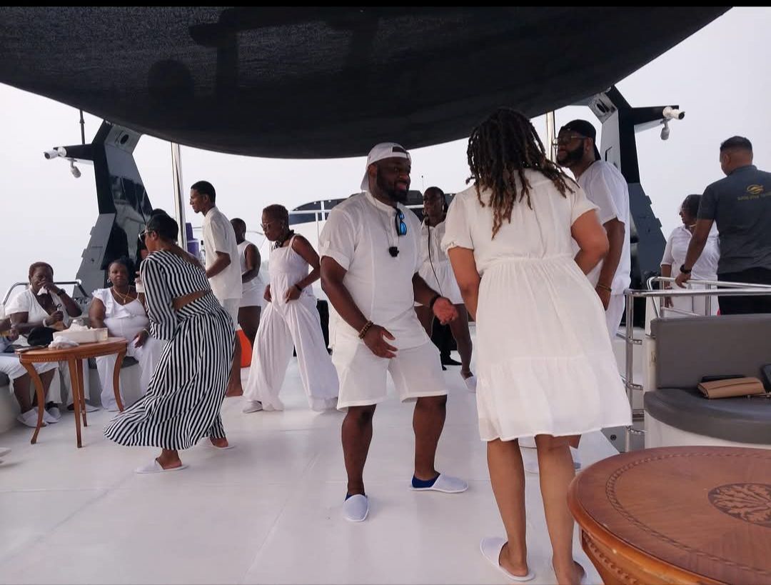 A group of people are dancing on a boat