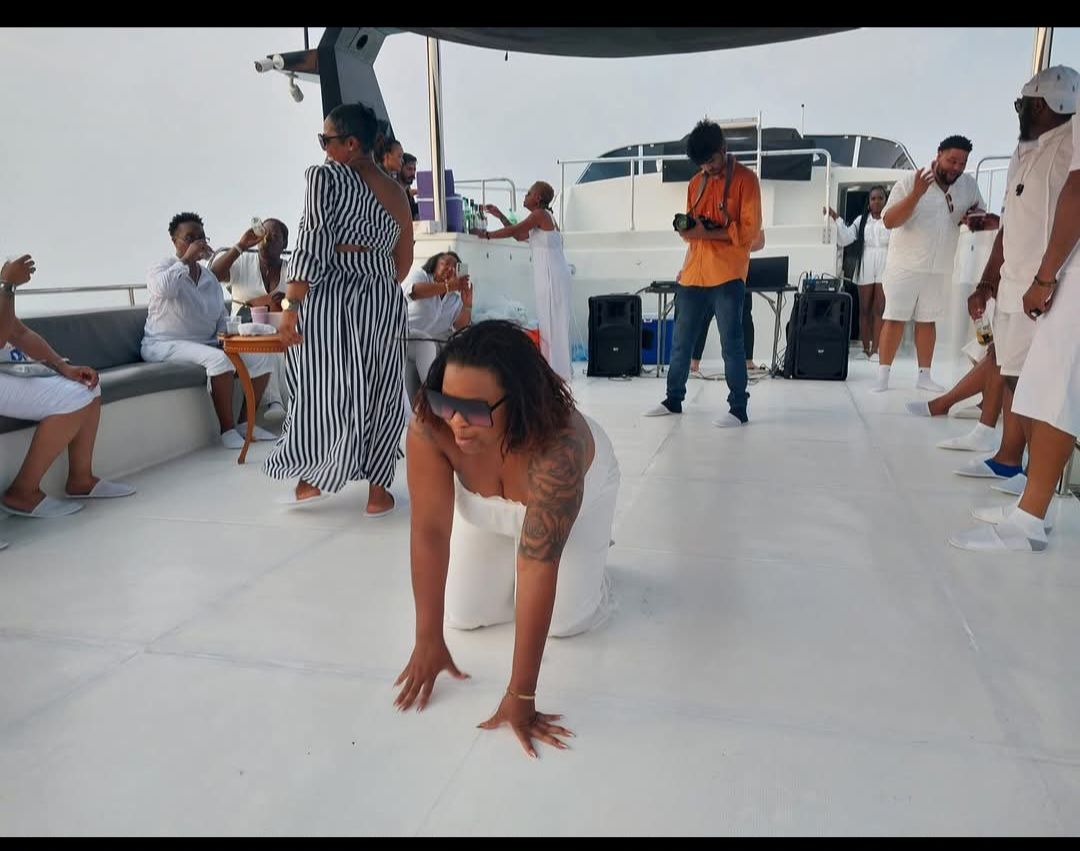 A group of people are dancing on a boat.