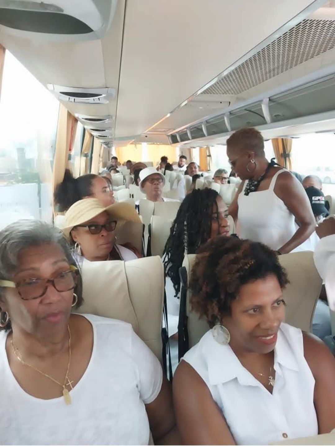 A group of women are sitting on a bus
