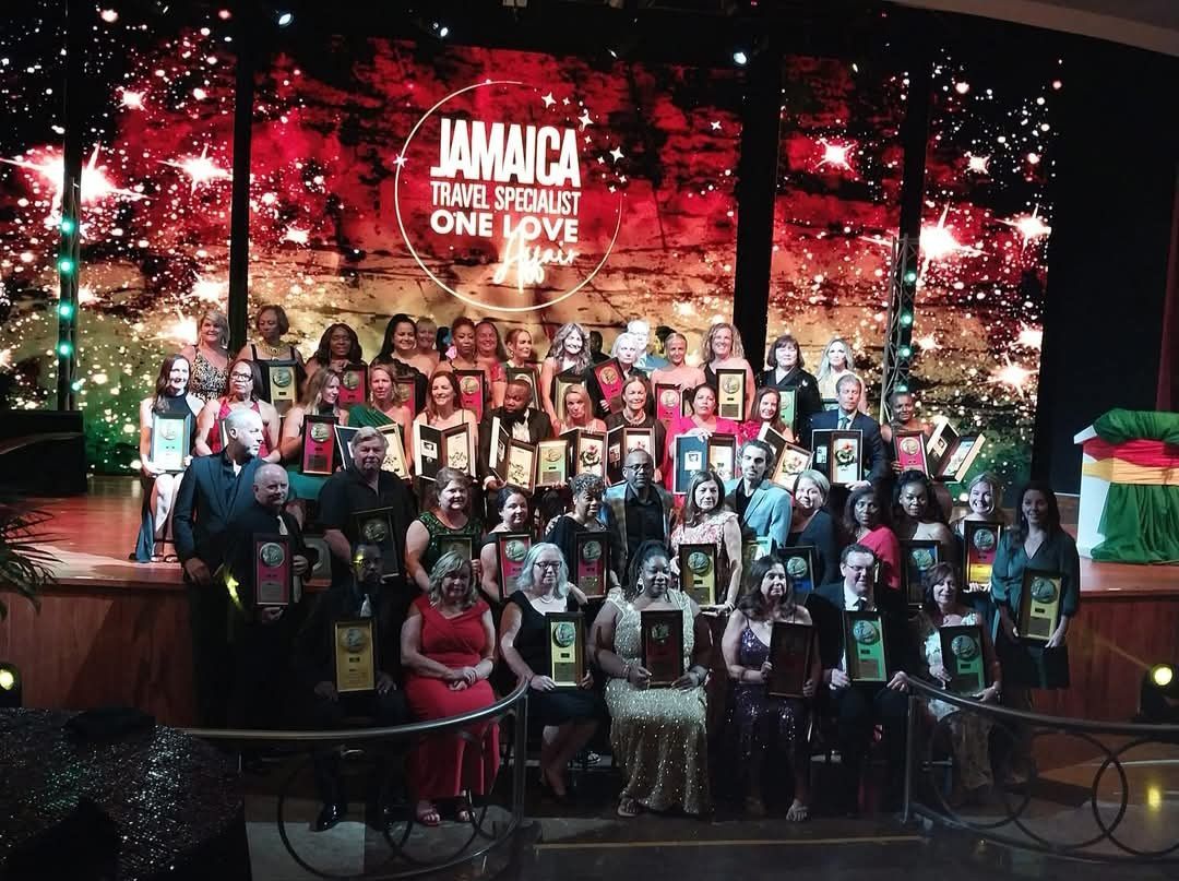 A group of people standing in front of a jamaica sign