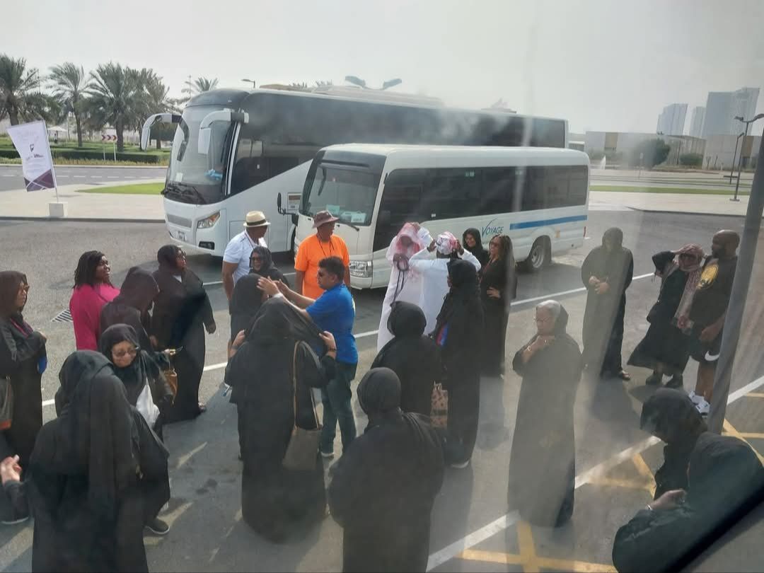 A group of people are standing in front of a bus
