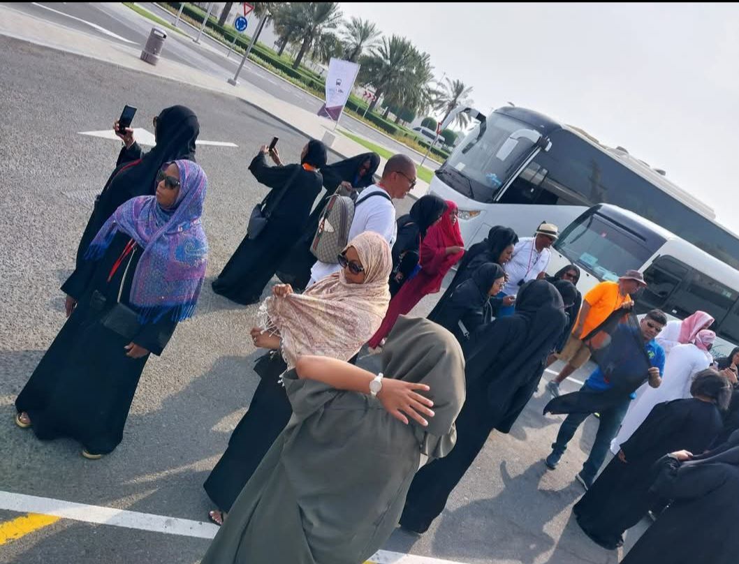 A group of people standing in front of a bus