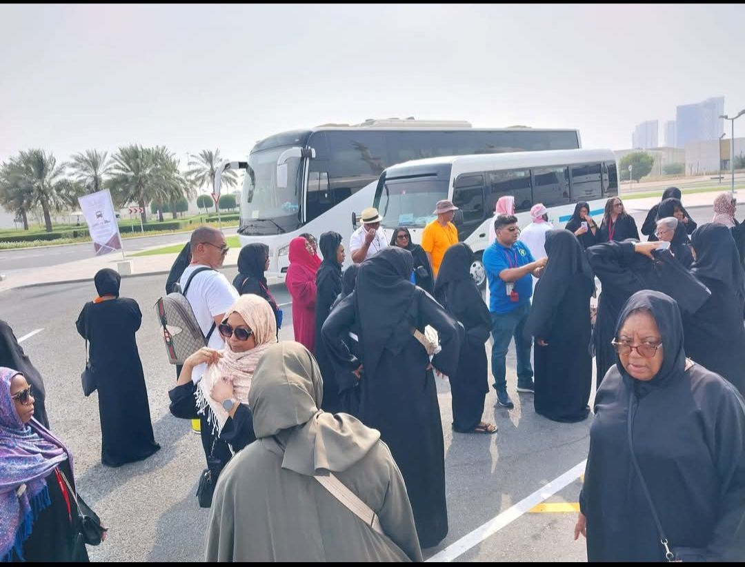 A group of people are standing in front of a bus