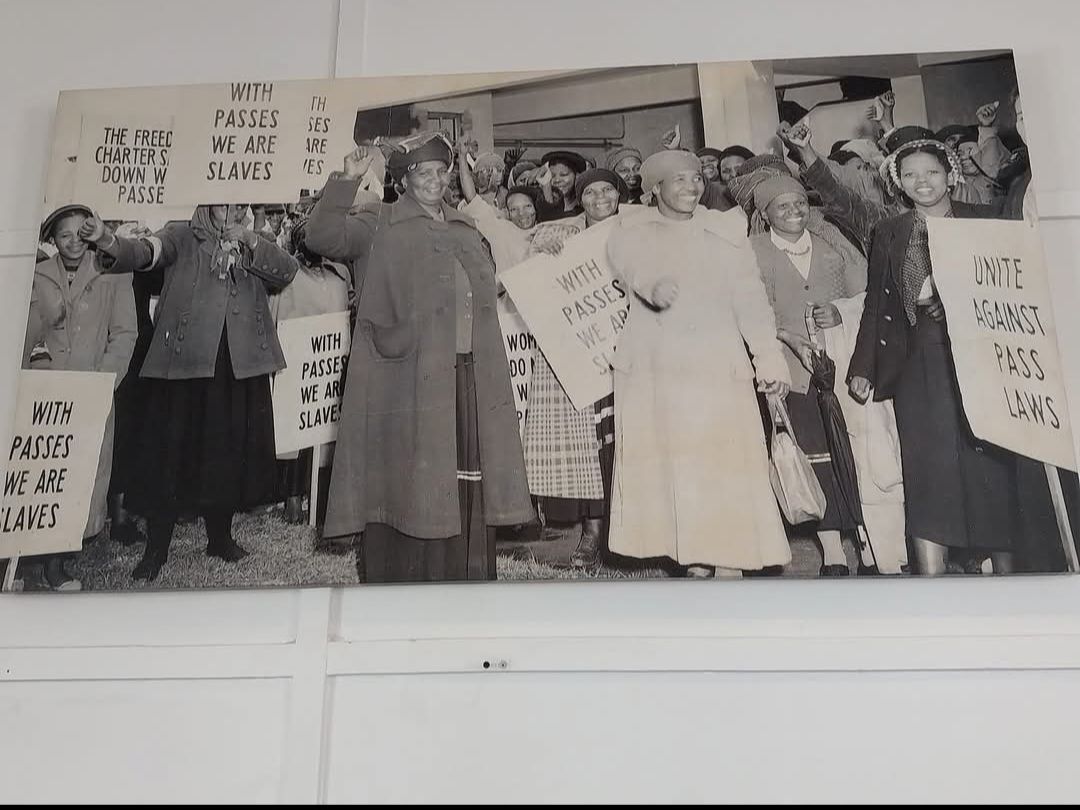 A black and white photo of a group of people holding signs