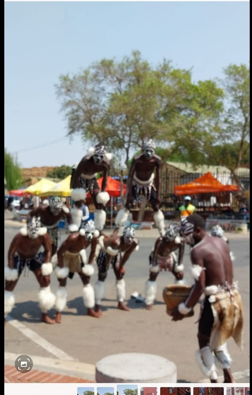 A group of people are dancing on a street
