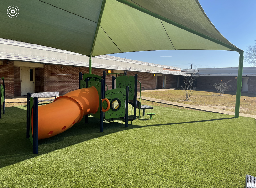 Soccer field in a backyard with two goals. Children play soccer on green turf.