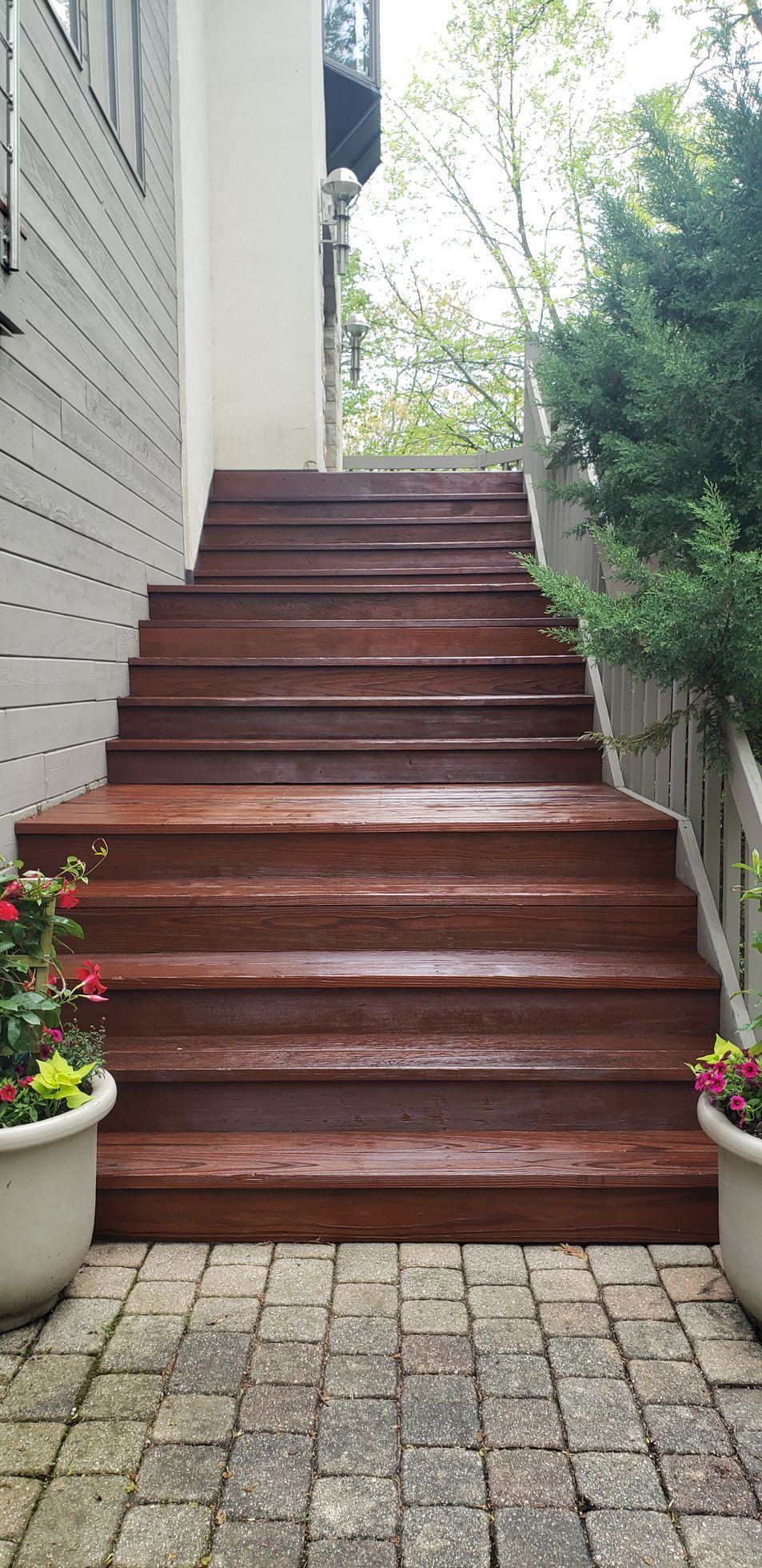 A set of wooden stairs leading up to a house.