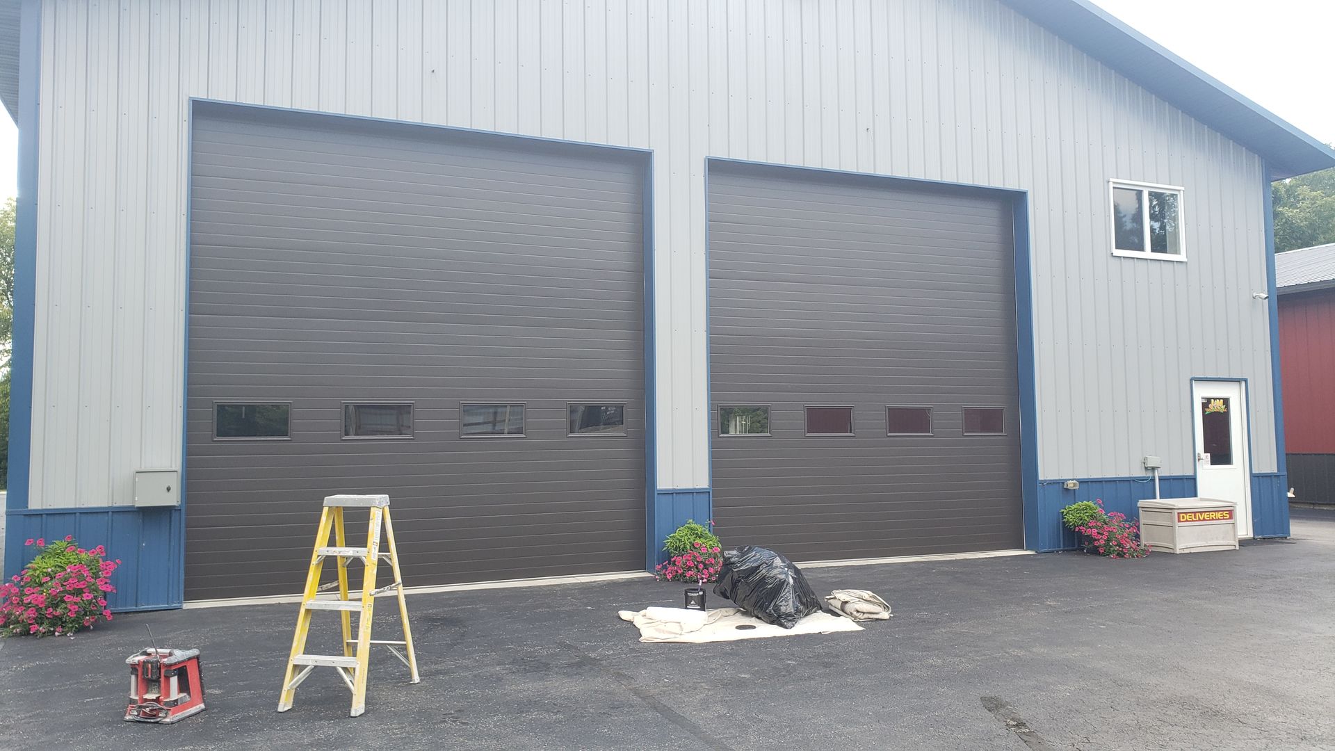 A garage door is being painted in front of a building