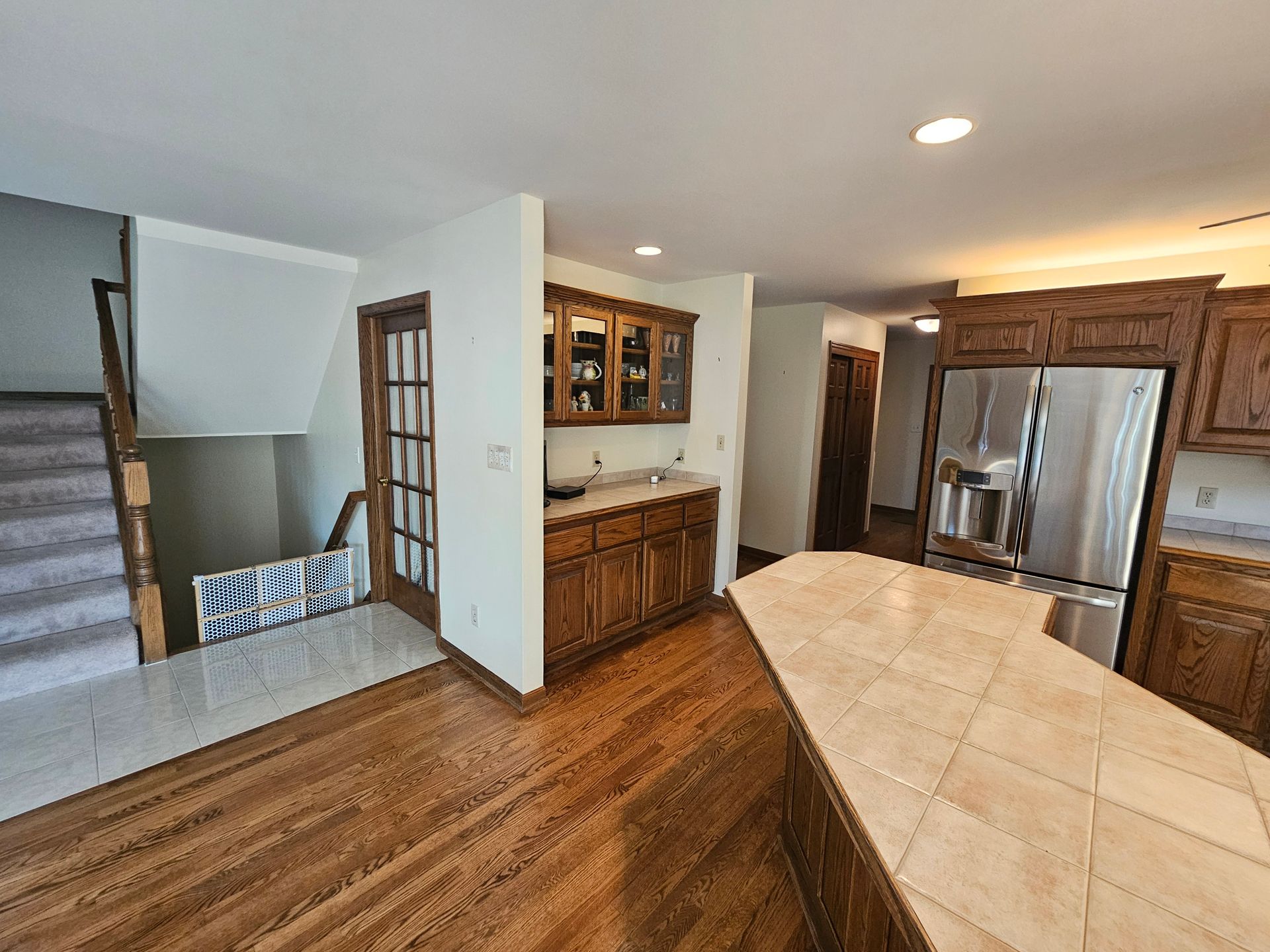 A kitchen with stainless steel appliances and wooden cabinets