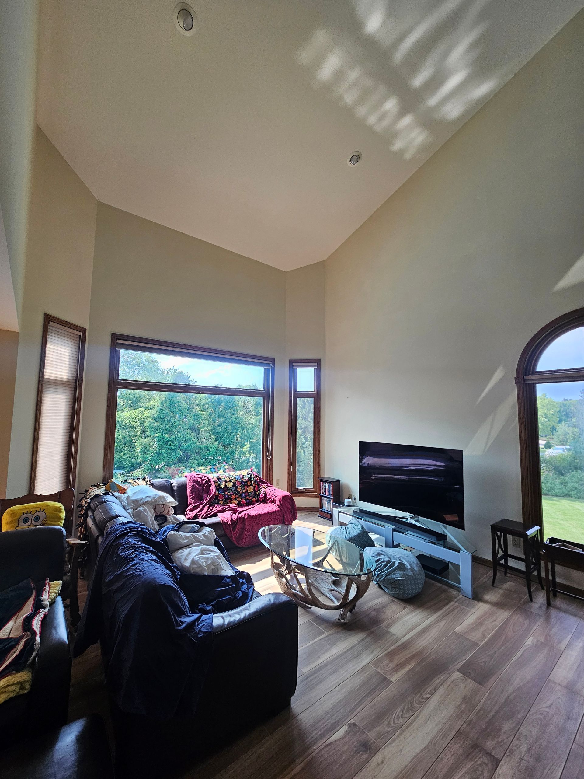 A living room with a vaulted ceiling and lots of windows