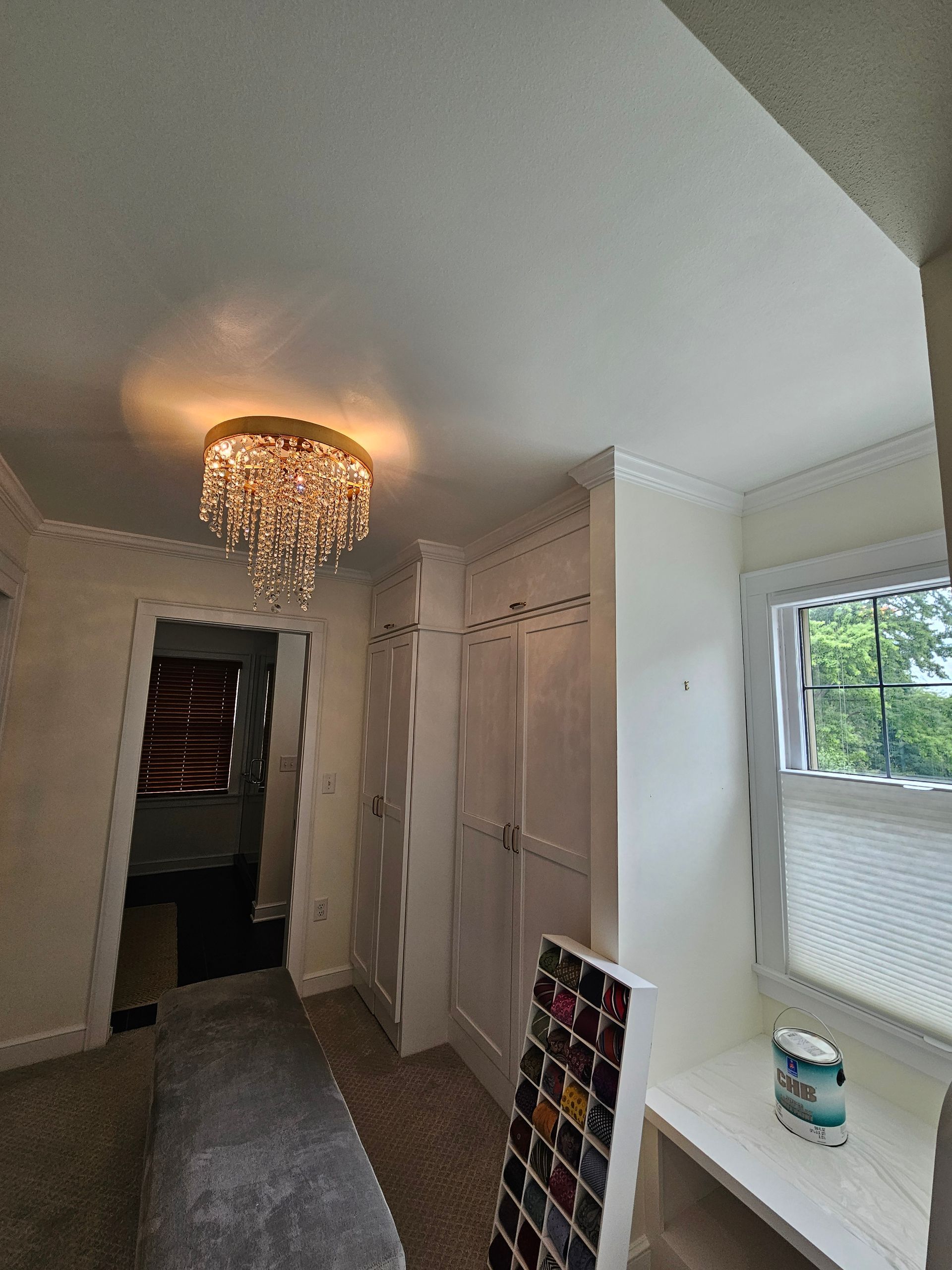 There is a chandelier in the ceiling of the room.