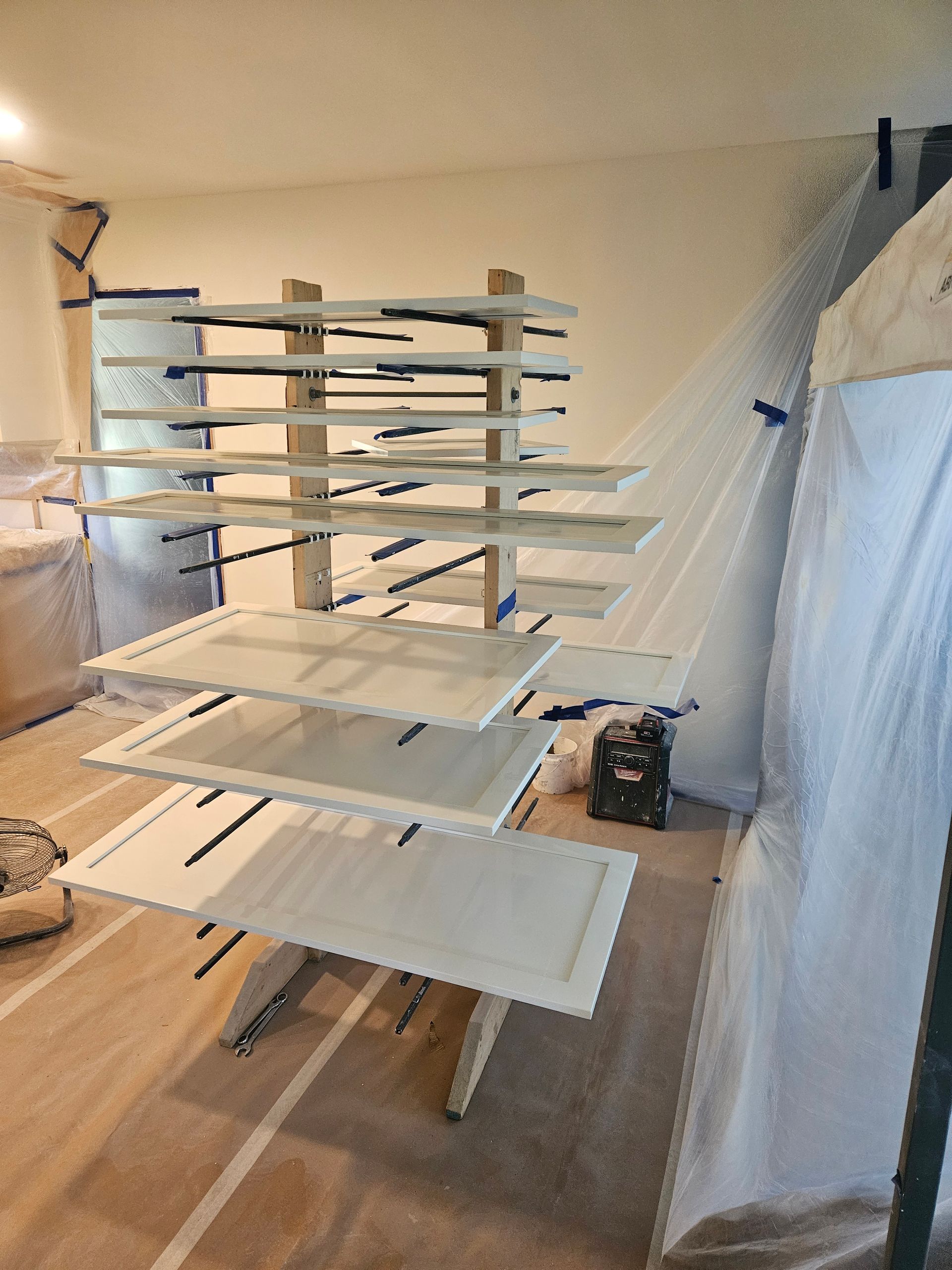 A room with a lot of white shelves stacked on top of each other