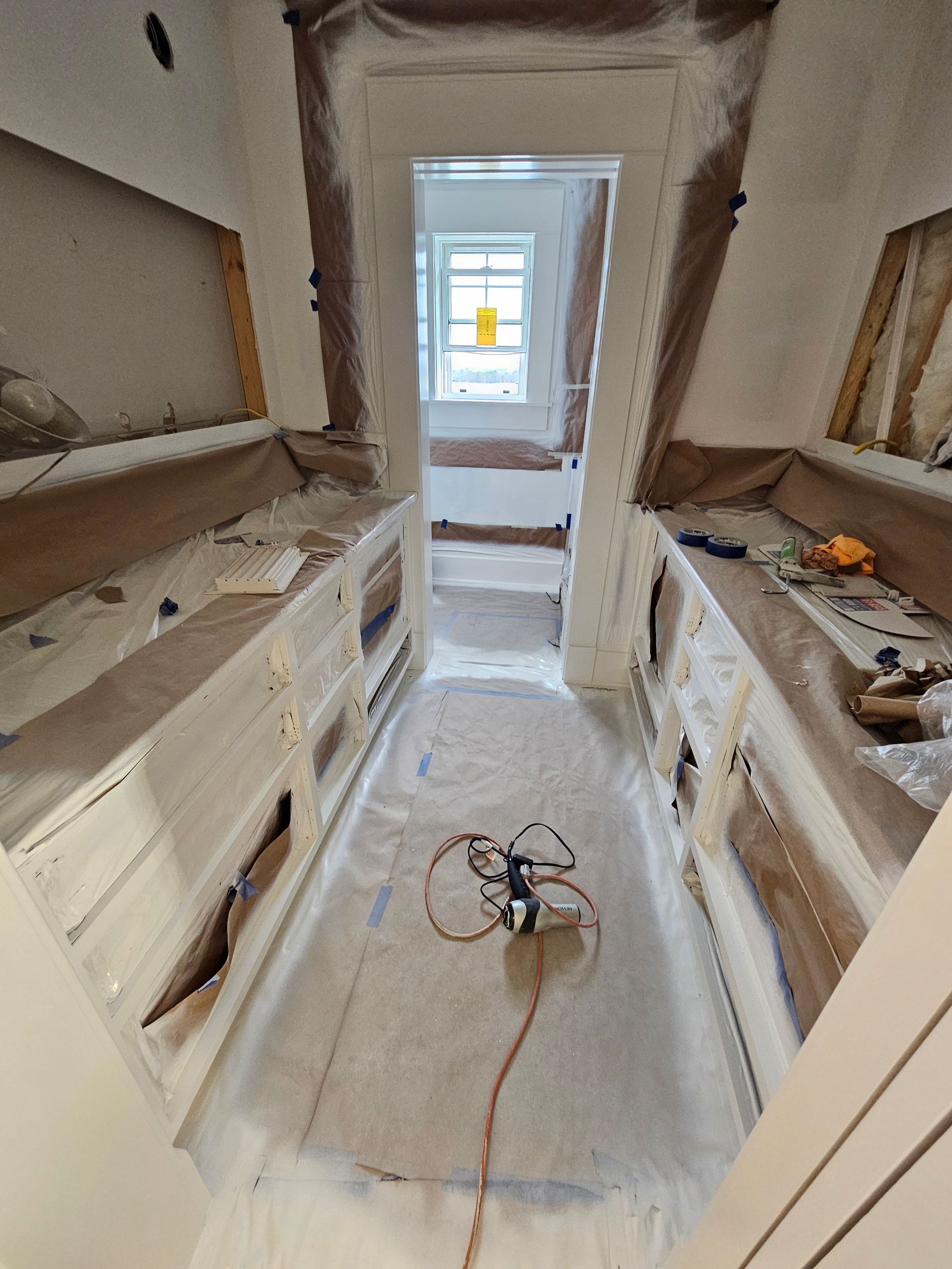 A room with a lot of cabinets and drawers being painted