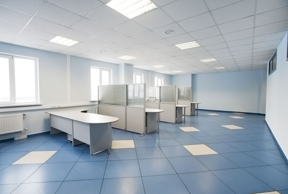 An Empty Office With Blue Tile Floors And Cubicles — East Coast Air In Newcastle, NSW
