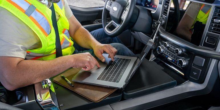 technician-programming-car-key-with-laptop-inside-car