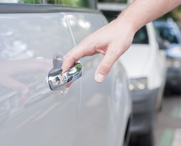 person-holding-fixed-car-door-handle