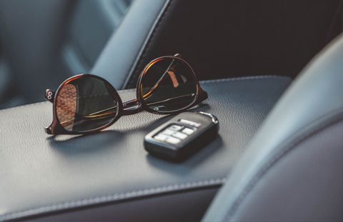 sunglasses-and-car-key-on-car-middle-console