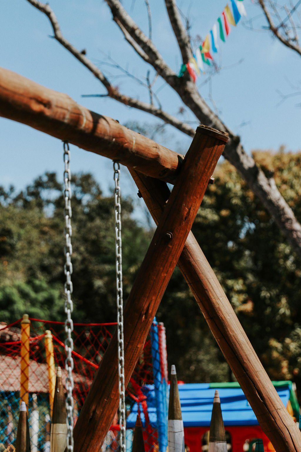 Um close de um balanço de madeira em um parque