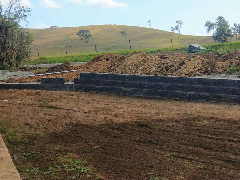 Grey brick wall and excavated road â Excavation in Alligator Creek, QLD