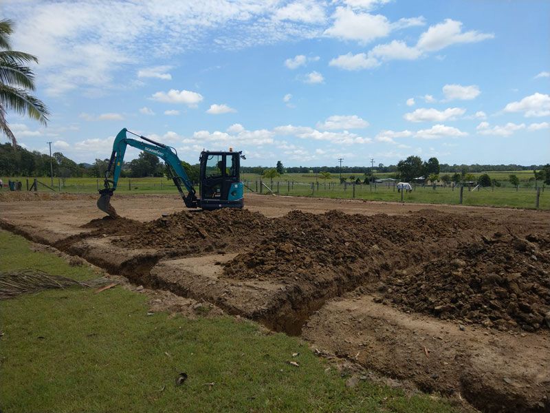 Blue excavator digging soil — Excavation in Alligator Creek, QLD