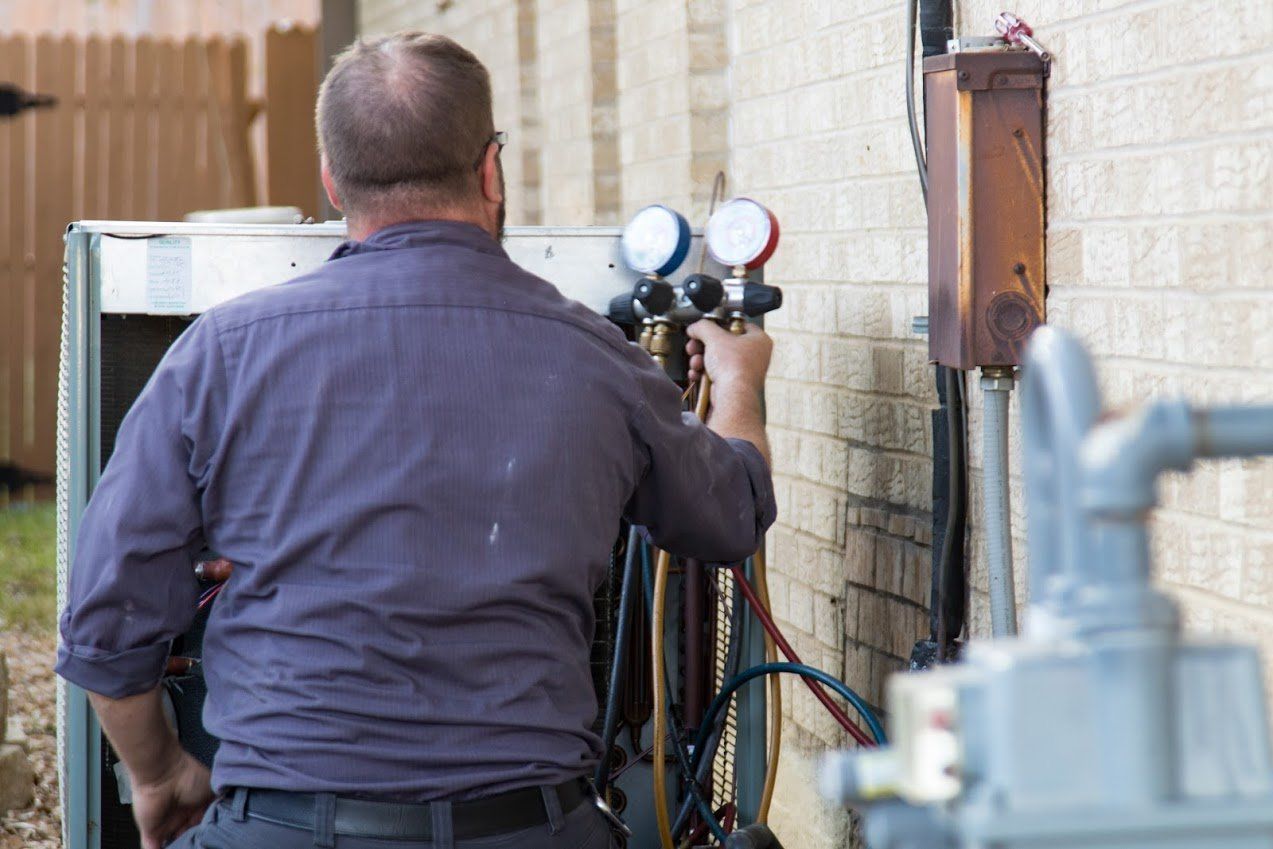 Air Conditioning Repair — Man Repairing Aircon in Irving, TX