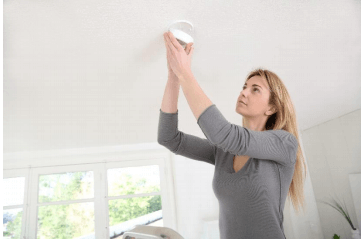 Woman Checks Up their Heating System — Blogs in Irving, TX