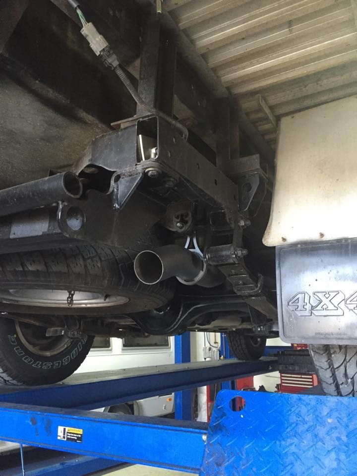 Undercarriage of a Vehicle on a Lift, Showing the Exhaust System — Carline Automotive and Exhausts in Belmont, NSW