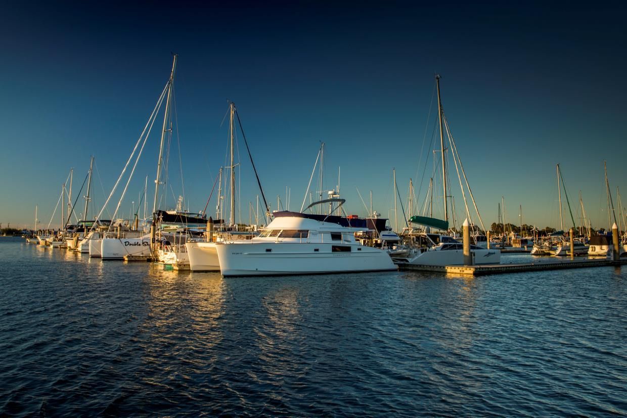A Row Of Sailboats Are Docked In A 
Marina On A Sunny Day — Little Mates Towing & Transport Pty Ltd In Gladstone, QLD