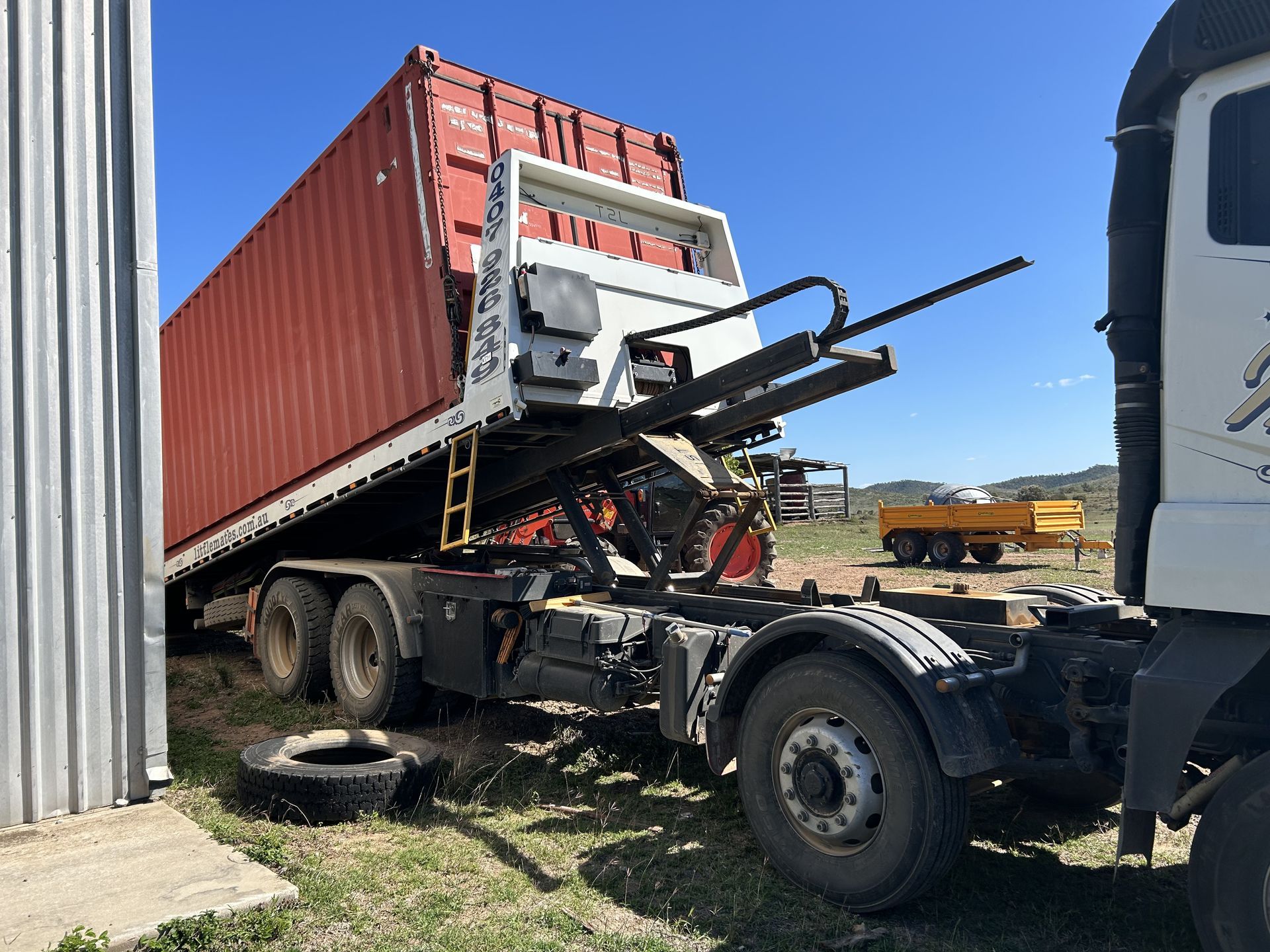 A White Car Is Being Towed By A Blue Tow Truck — Little Mates Towing & Transport Pty Ltd In Glenlee, QLD