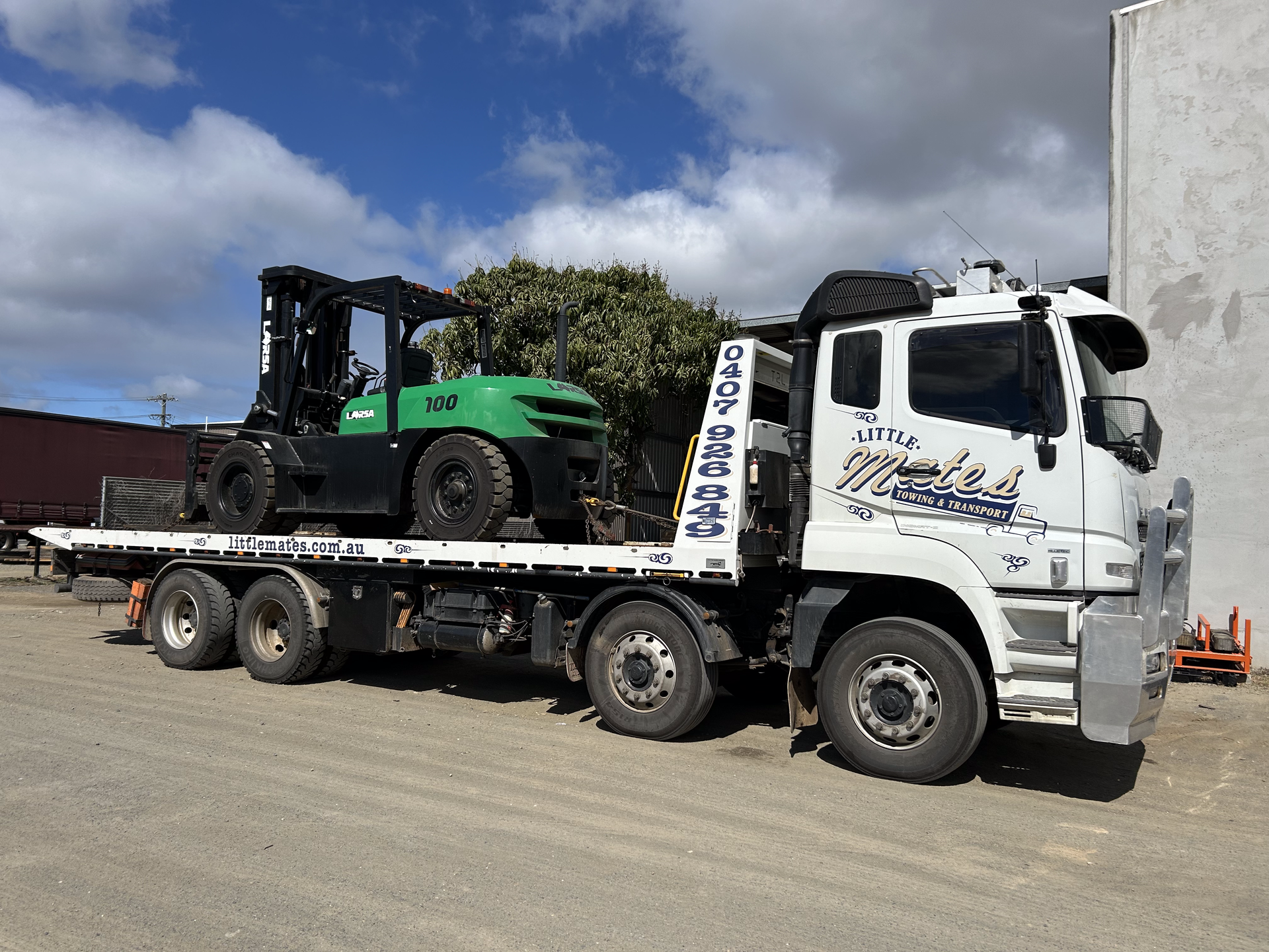 A white tow truck with a green forklift on the back of it — Little Mates Towing & Transport Pty Ltd In Glenlee, QLD