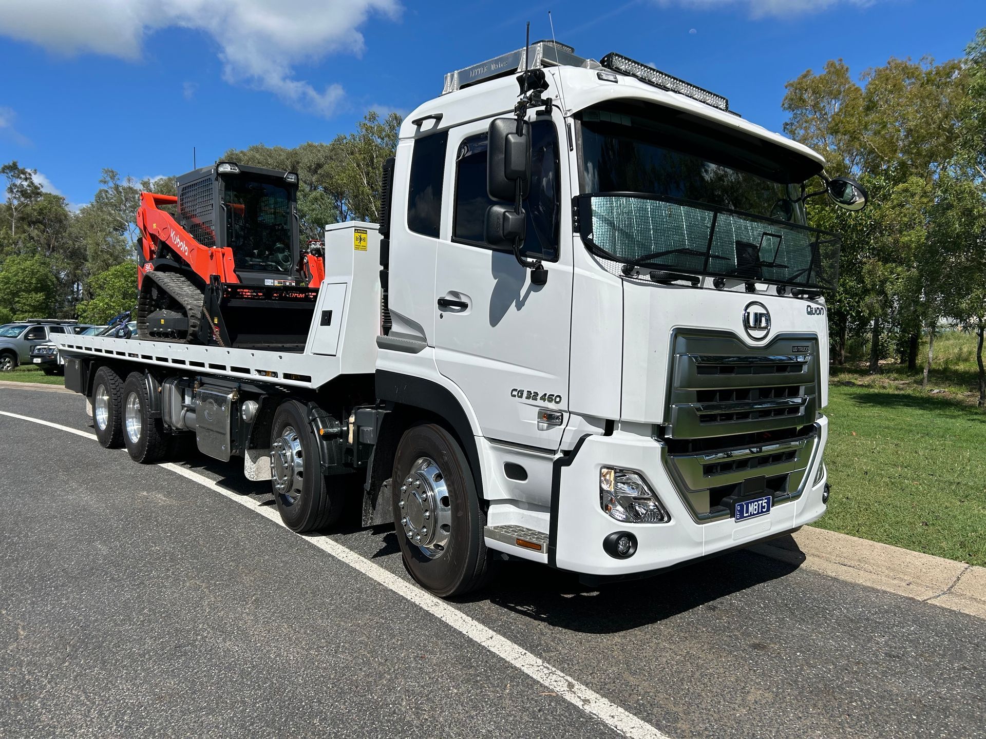 Two Trucks Are Parked Next To Each Other On A Dirt Road — Little Mates Towing & Transport Pty Ltd In Glenlee, QLD