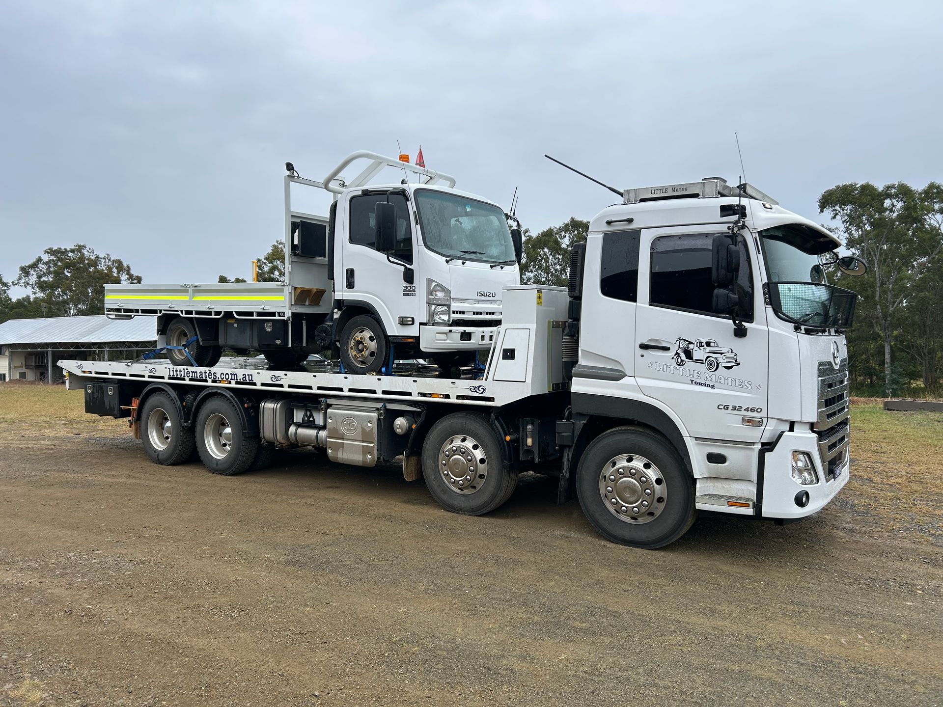 A White Car Is Being Towed By A Tow Truck — Little Mates Towing & Transport Pty Ltd In Glenlee, QLD