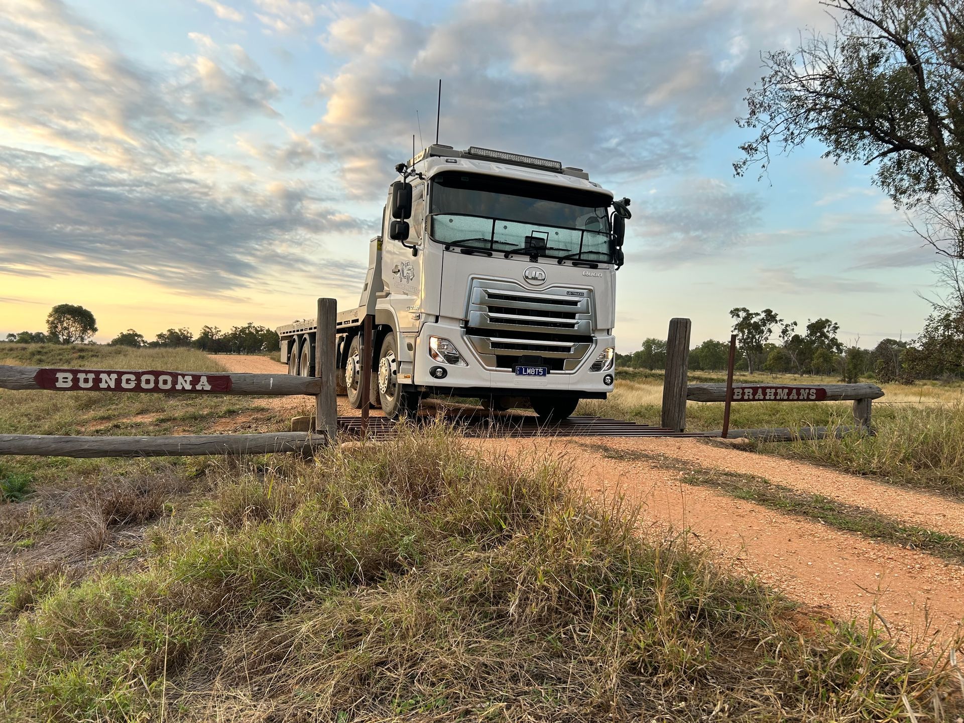 A Red Car Is Being Towed By A Tow Truck — Little Mates Towing & Transport Pty Ltd In Glenlee, QLD