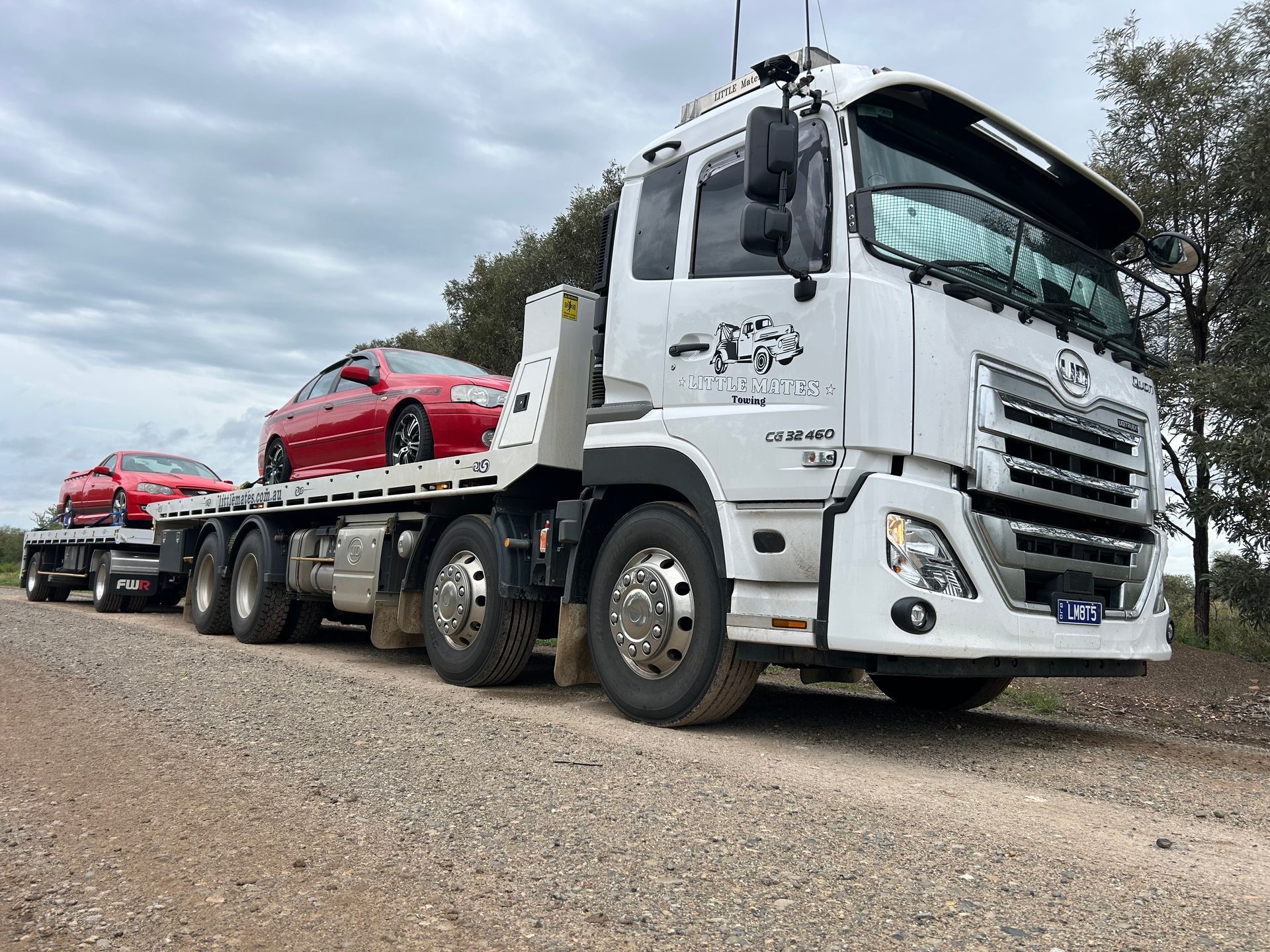 A Red Truck Is Sitting On Top Of A Tow Truck — Little Mates Towing & Transport Pty Ltd In Emerald, QLD