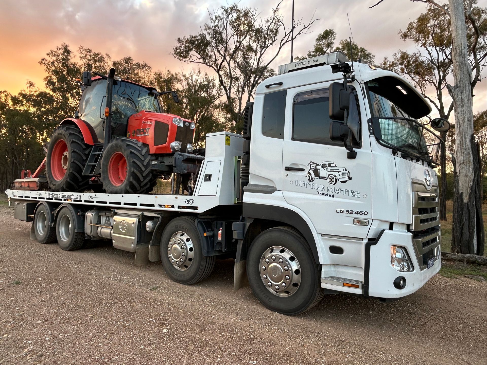 A Red Car Is Being Towed By A Tow Truck On The Side Of The Road — Little Mates Towing & Transport Pty Ltd In Emerald, QLD