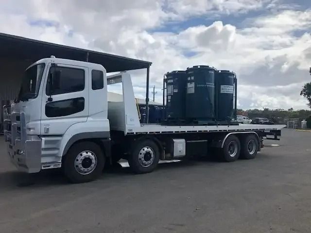 A White Truck With A Flatbed Is Parked In A Parking Lot — Little Mates Towing & Transport Pty Ltd In Glenlee, QLD