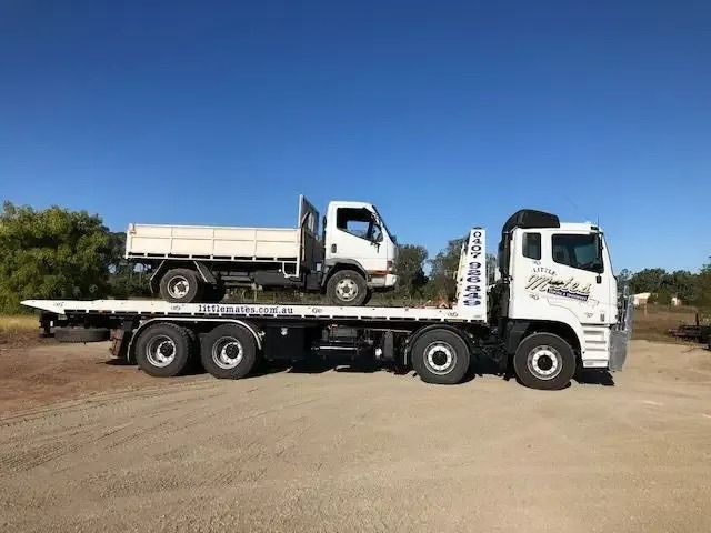 Two Trucks Are Parked Next To Each Other On A Dirt Road — Little Mates Towing & Transport Pty Ltd In Glenlee, QLD