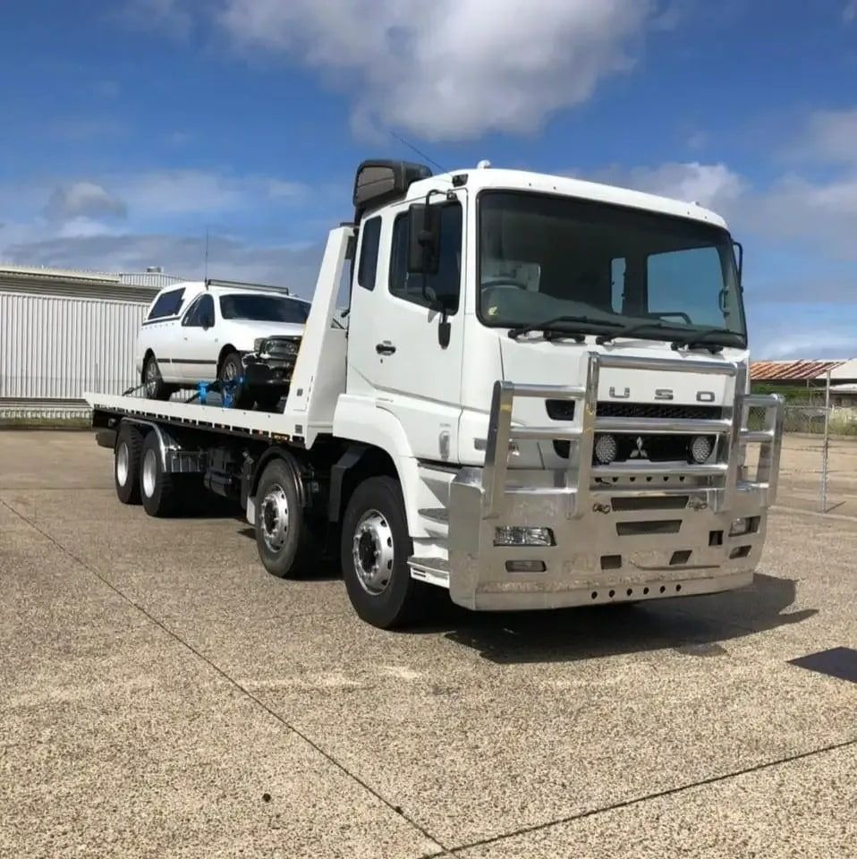 A White Tow Truck Is Parked In A Parking Lot — Little Mates Towing & Transport Pty Ltd In Glenlee, QLD