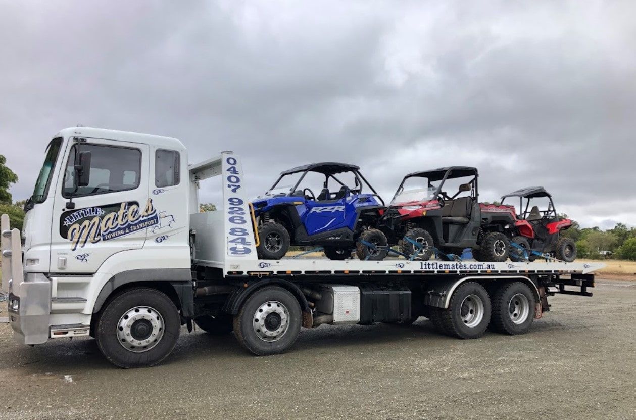 A Tow Truck Is Carrying Four Atvs On Its Flatbed — Little Mates Towing & Transport Pty Ltd In Glenlee, QLD