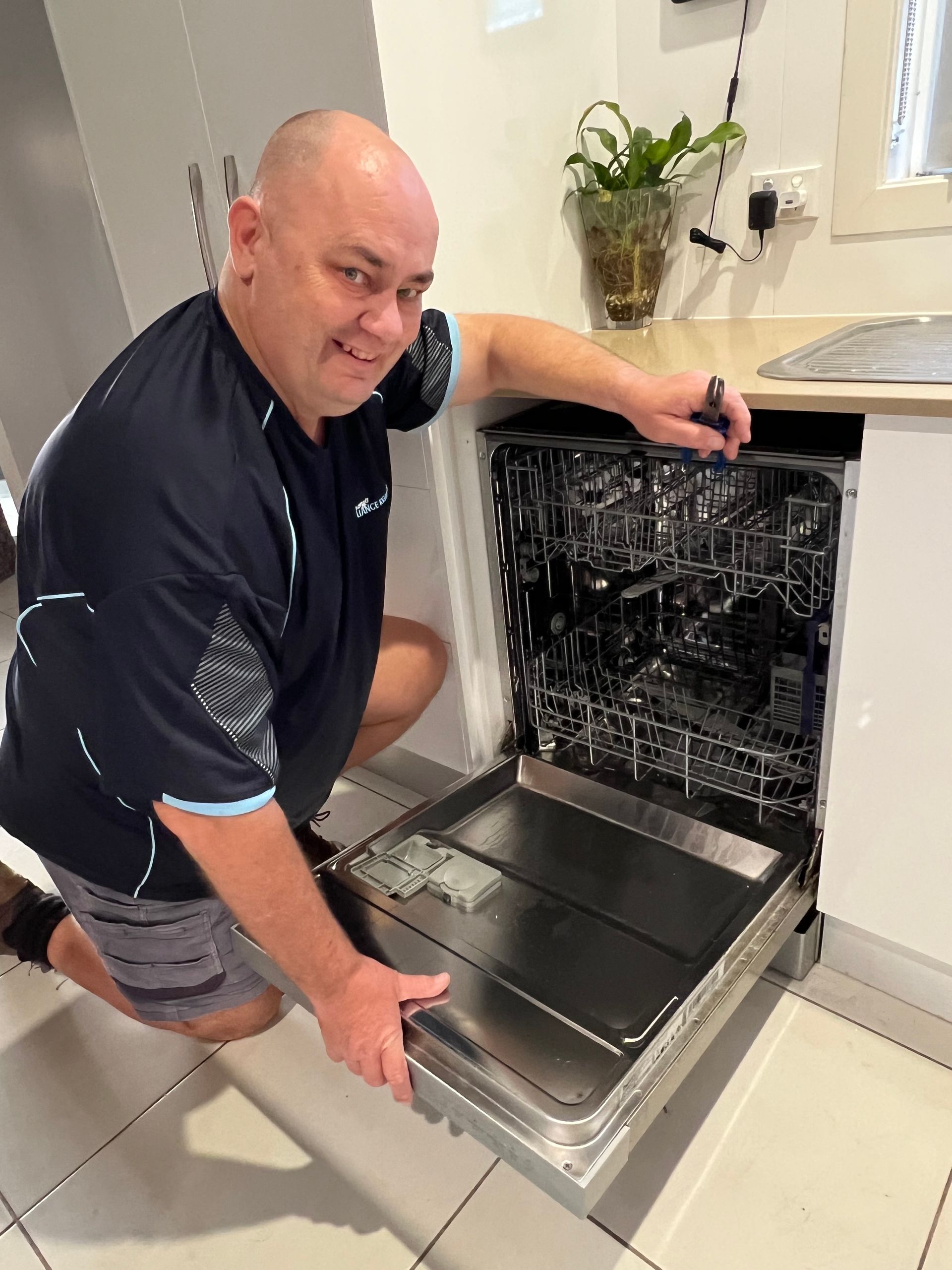 Repairman Checking Dishwasher - Appliance Repairs in Taree, NSW