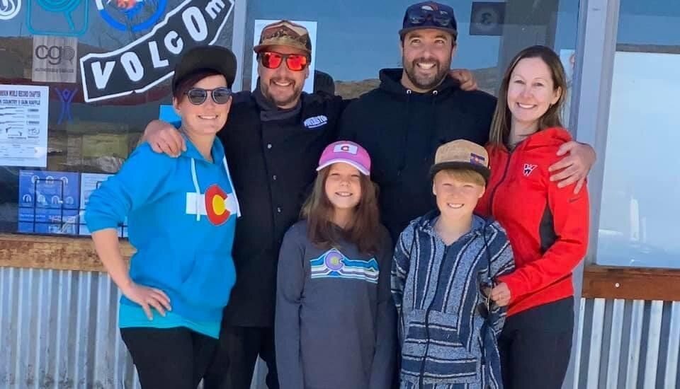 A group of people are posing for a picture in front of a building.