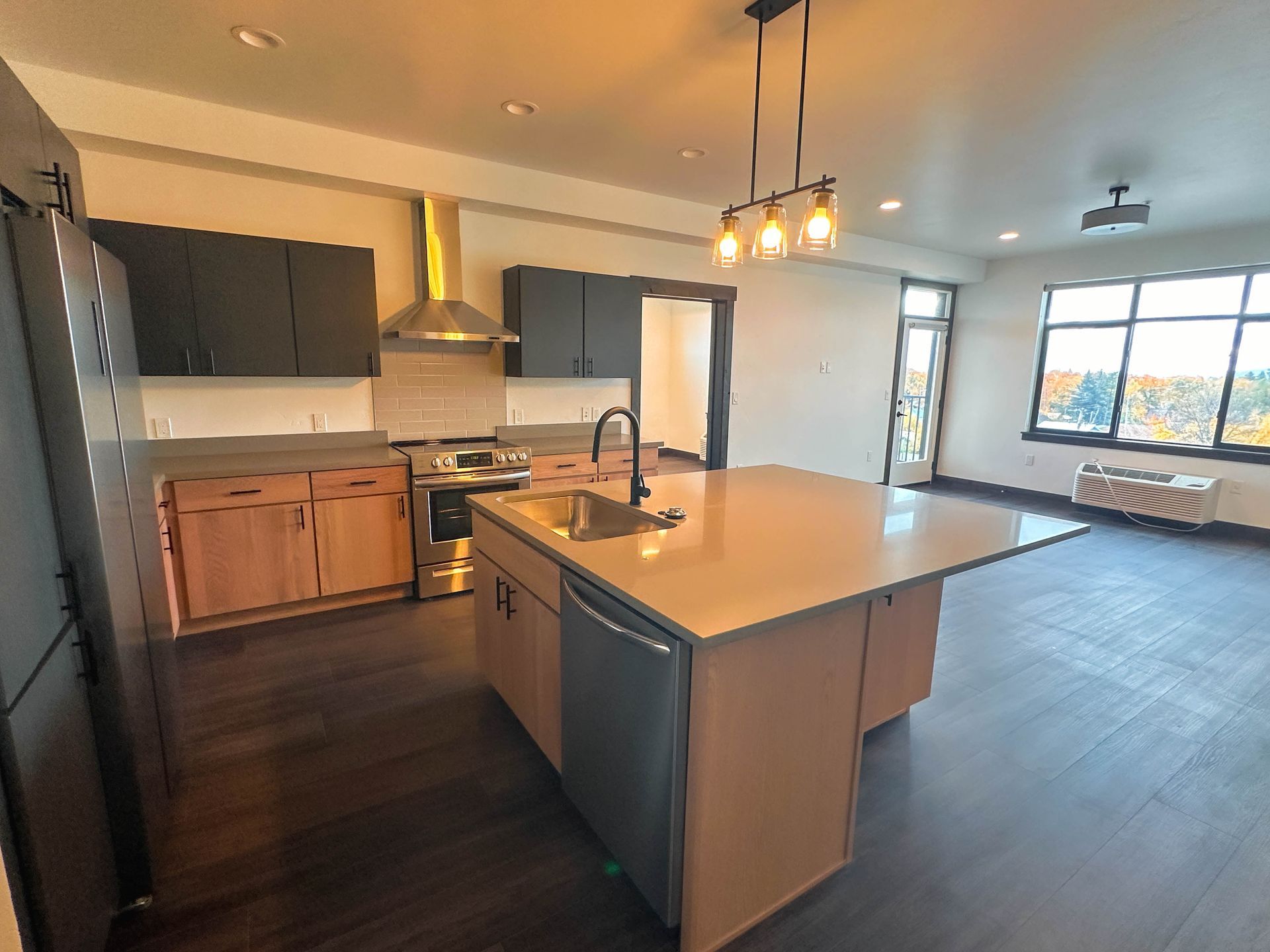 a kitchen with a large island and stainless steel appliances